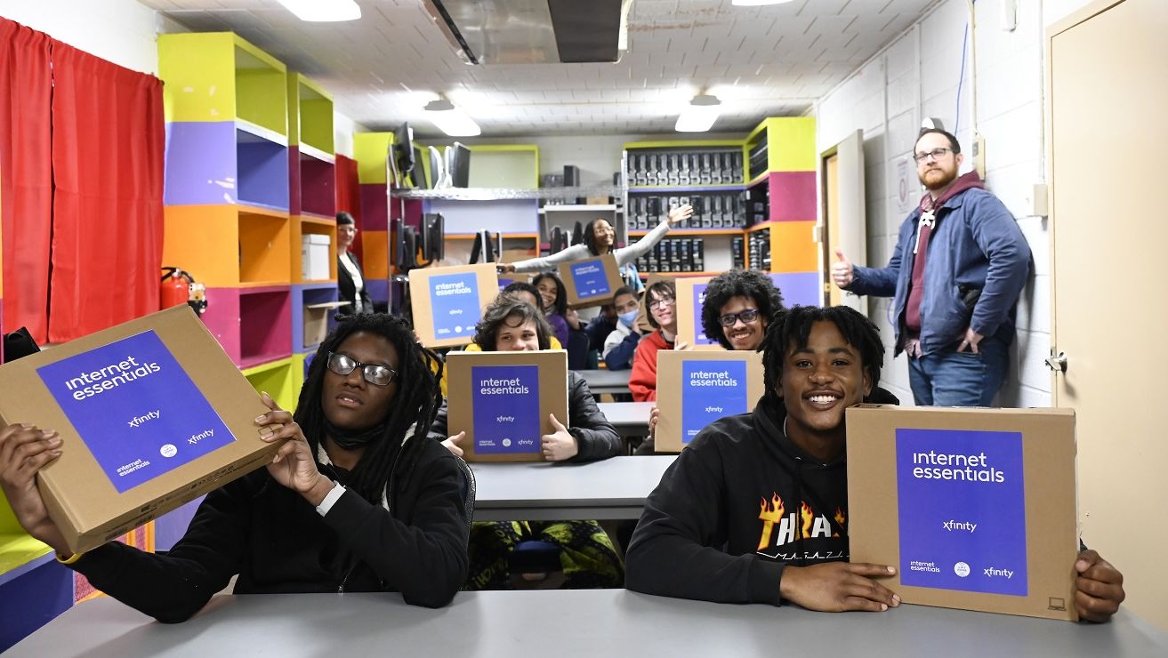 North Philadelphia youth smile for cameras inside Temple University’s Digital Equity Center.