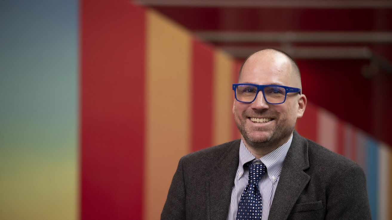 Dustin Kidd wearing blue glasses 