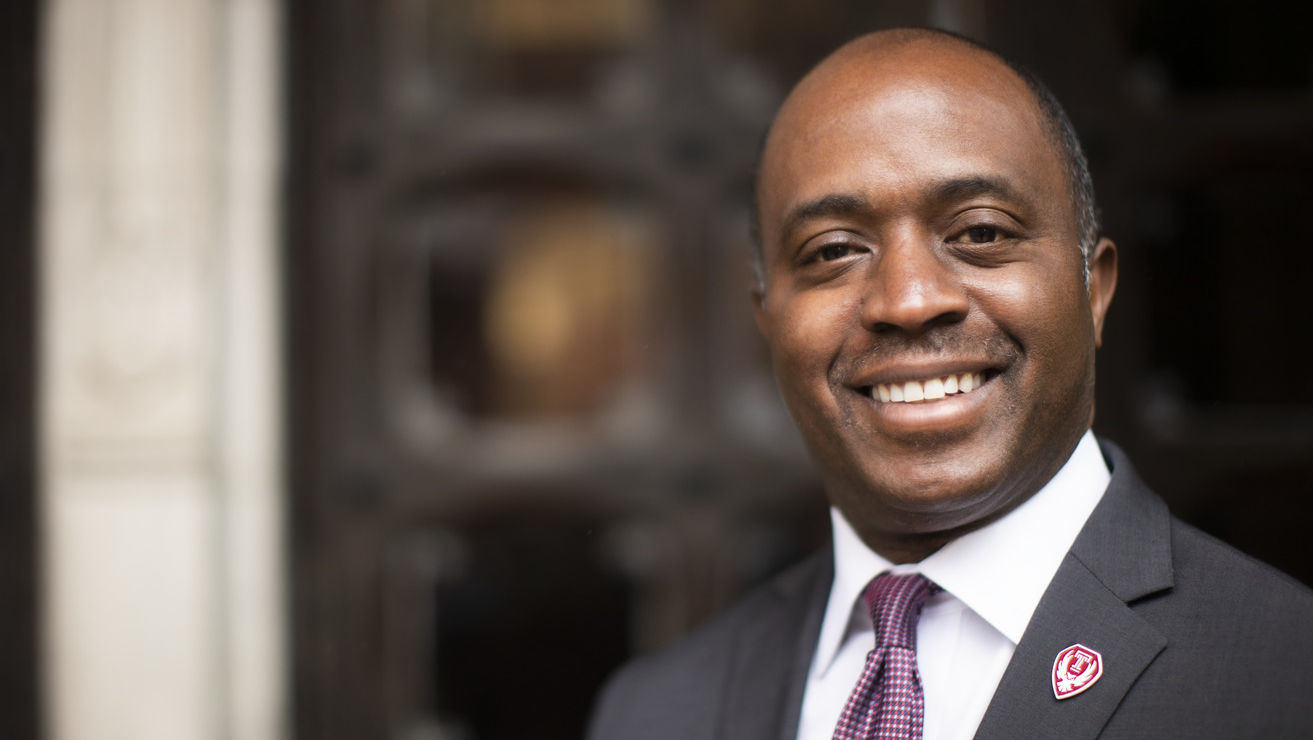 mage of Tony Thurmond in a suit and tie with an Owlmark lapel pin.