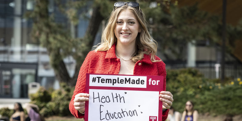 Meredith Kearney holding a Temple Made for sign