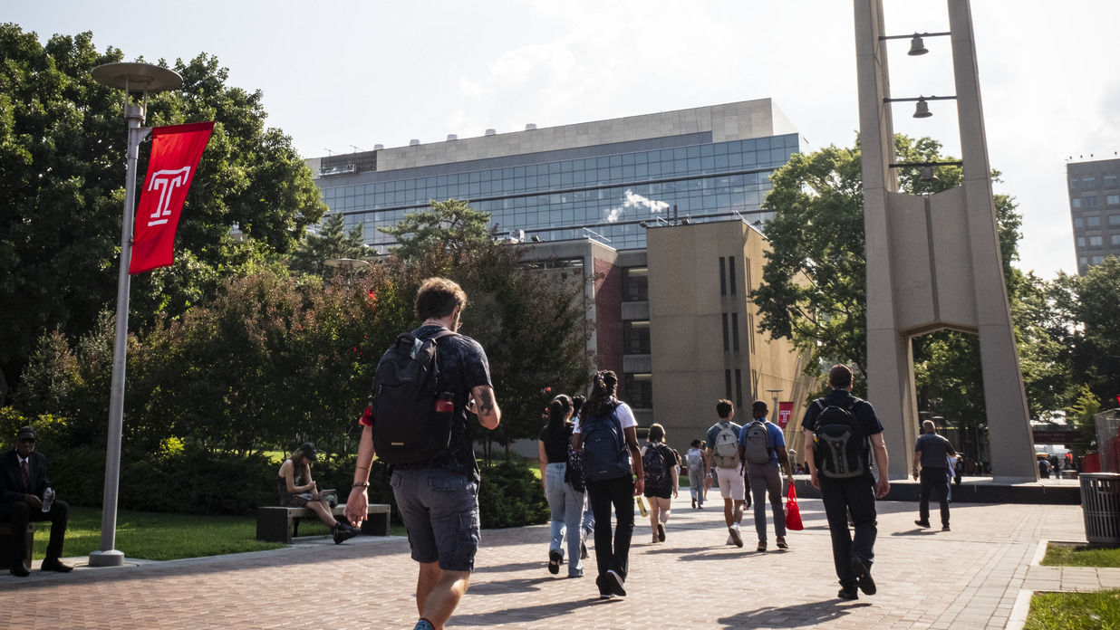 Students walking by the bell tower 