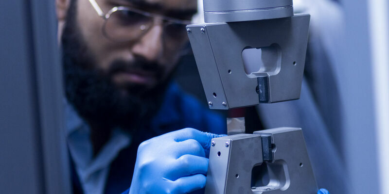 A graduate researcher working in the Electric Vehicle Safety Lab
