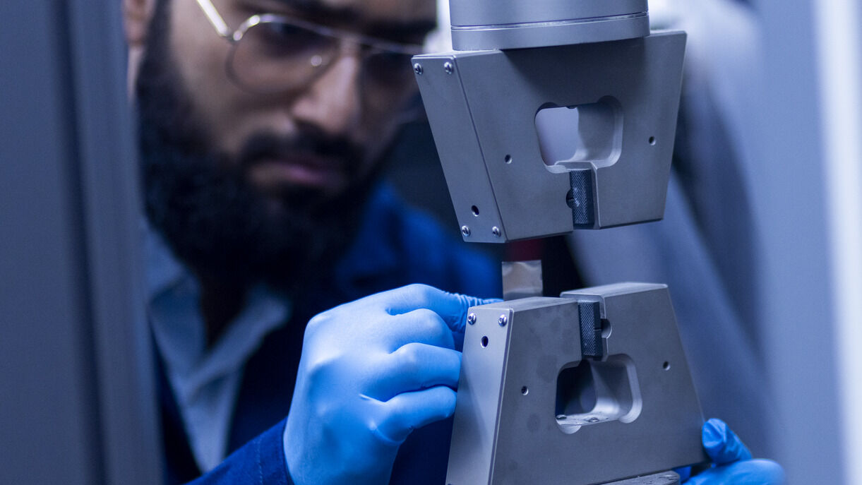 A graduate researcher working in the Electric Vehicle Safety Lab
