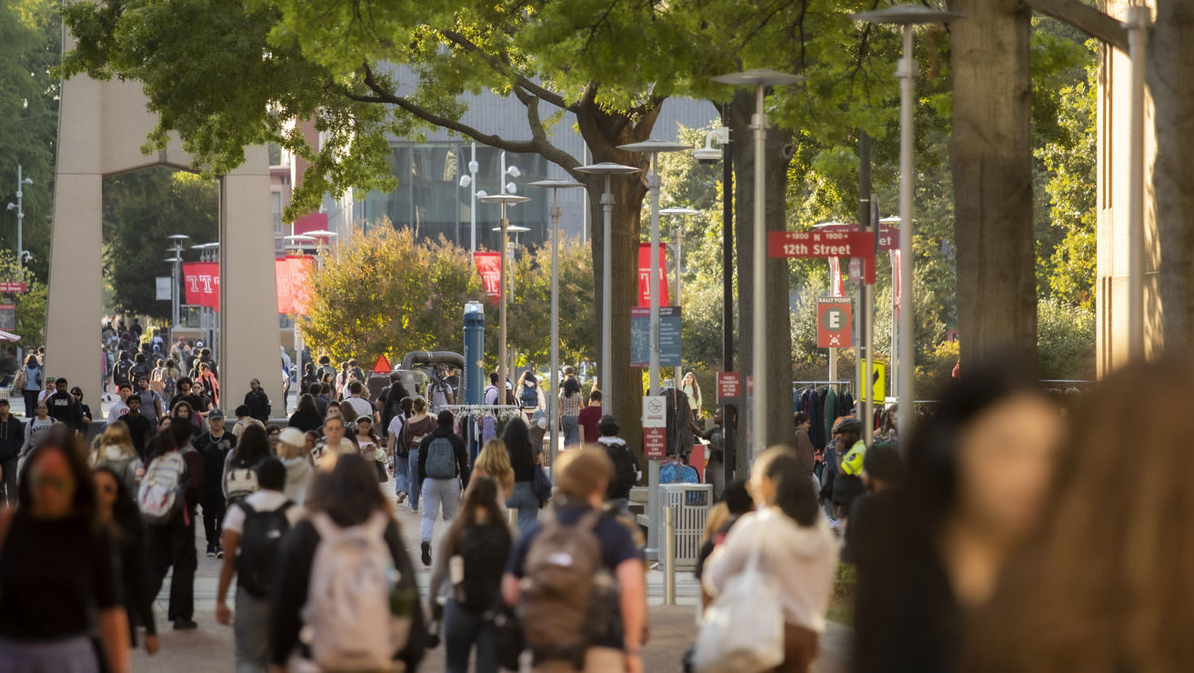 A campus scene of lots of students.