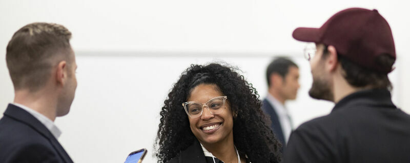 Image of people smiling inside the first-floor event space in Charles Library.
