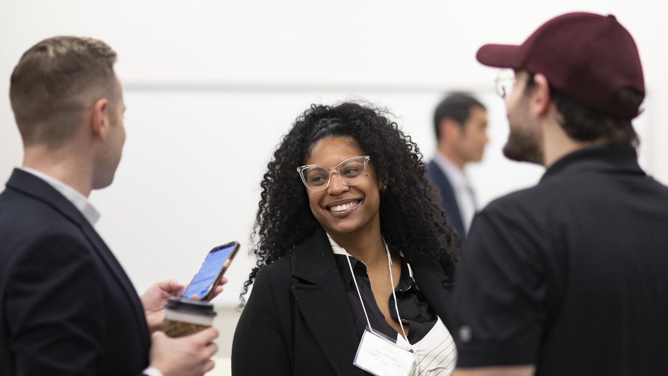 Image of people smiling inside the first-floor event space in Charles Library.