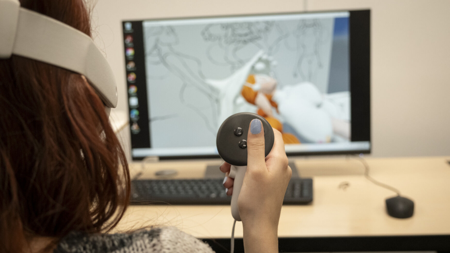 A student using virtual reality technology at a computer to illustrate