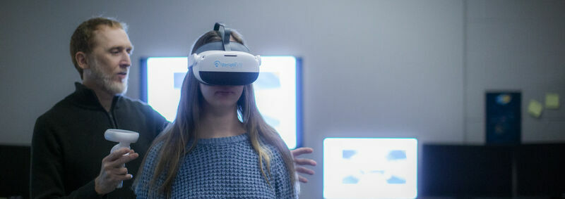 W. Geoffrey Wright with a research assistant wearing the UprightVR headset in the Motion-Action-Perception Laboratory 
