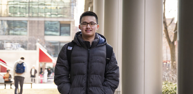 Edmond Tsan walks through campus
