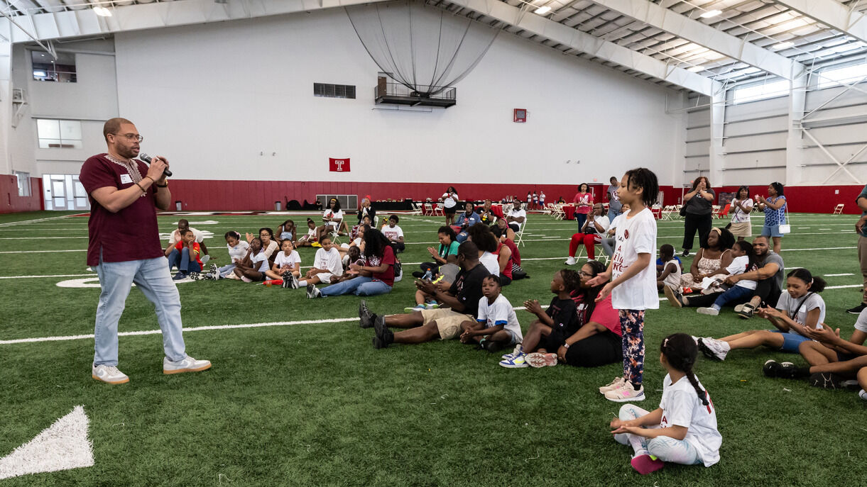 Image of Timothy Welbeck addressing the crowd at the Family Field Day event.