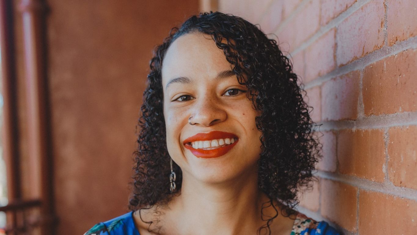  Image of Carissa Harris standing in a floral-printed outfit.