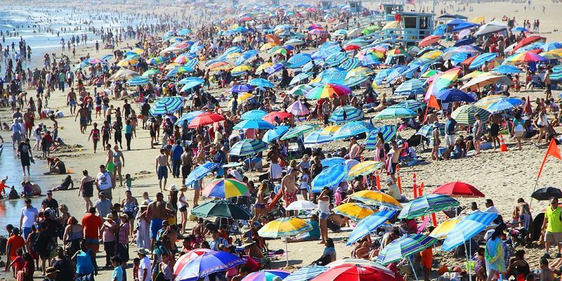 Crowded beach pictured.