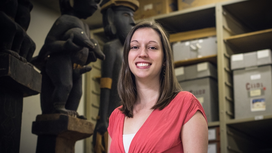 Melissa Krug standing with ancient artifacts in the background. 