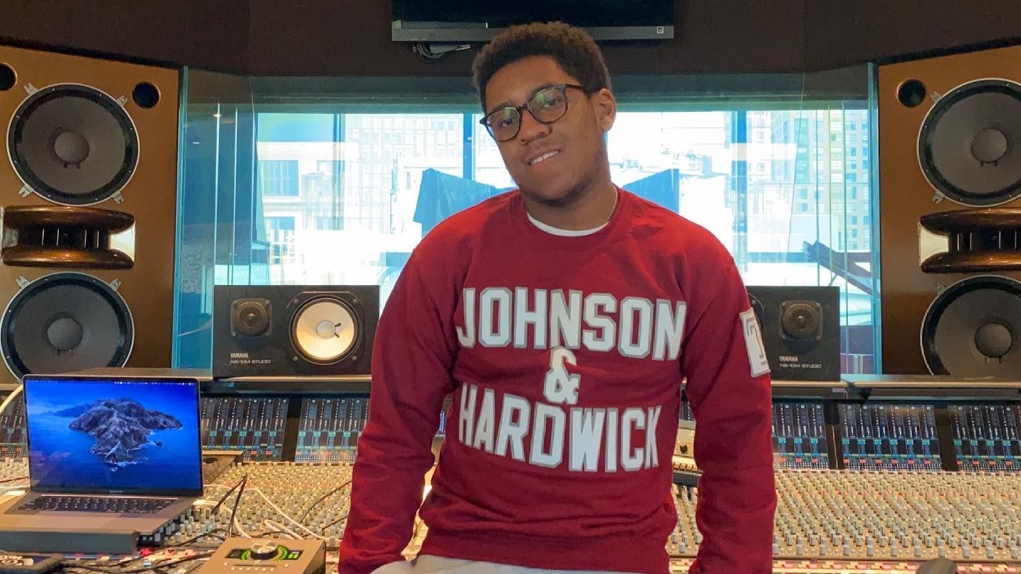 Ben Thomas wearing a Johnson & Hardwick sweatshirt in a studio