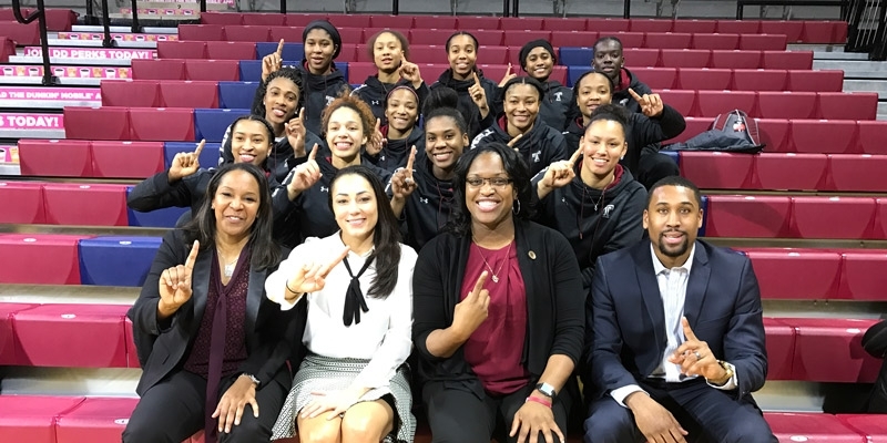 the Temple women’s basketball team holding up their fingers to signify No. 1.