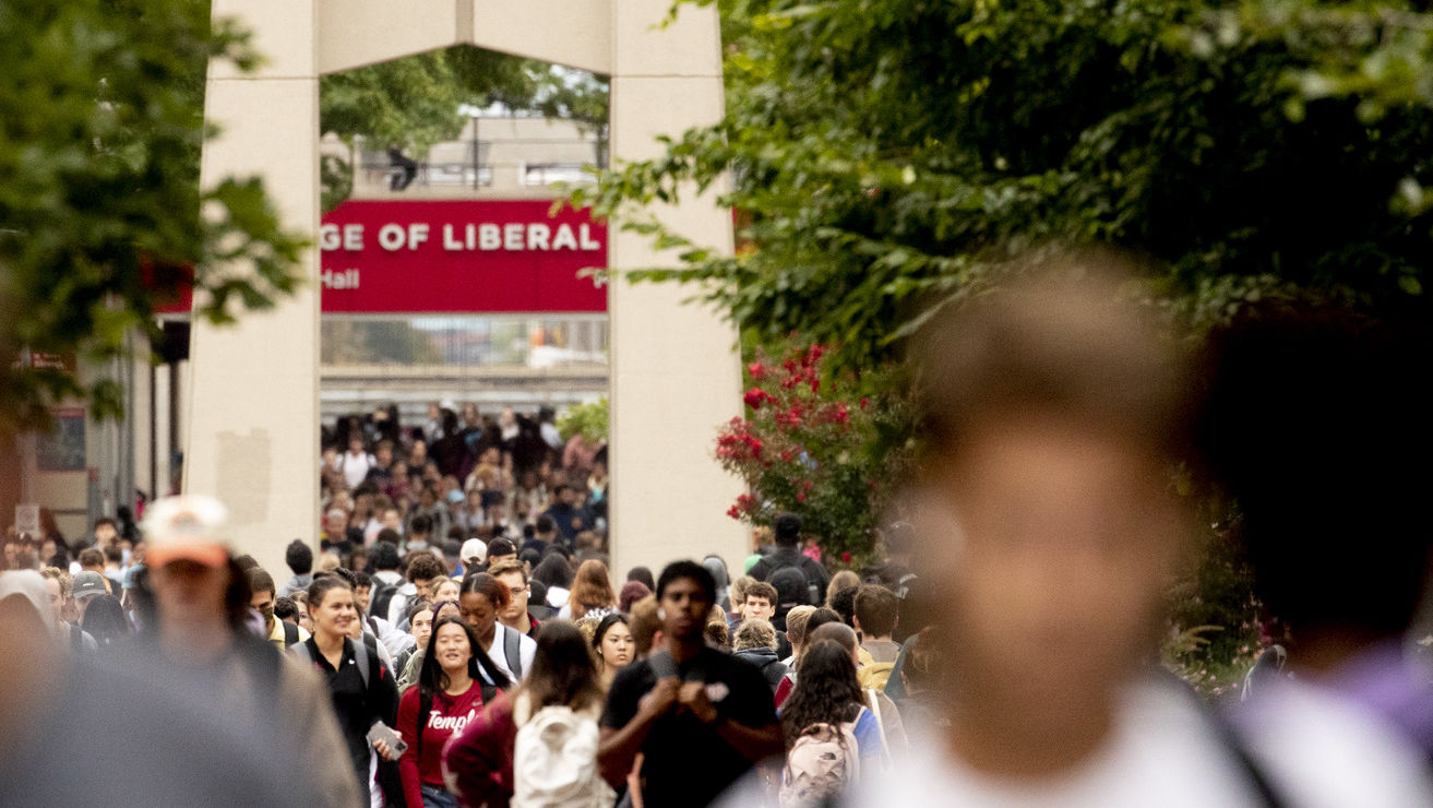 Students on campus near the bell tower. 