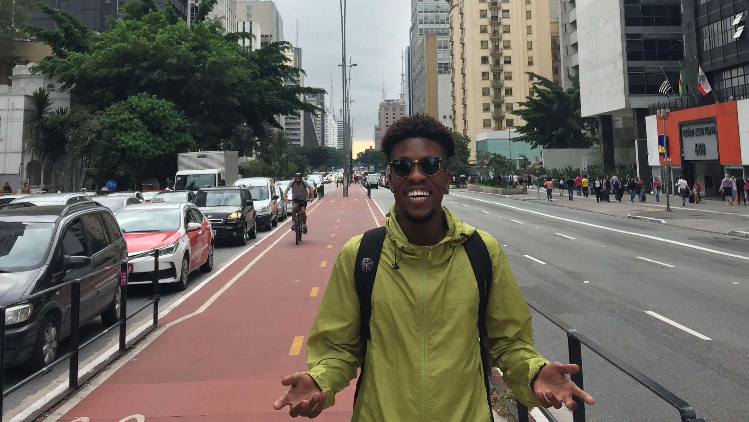 Xavier Burke standing at the center of a busy road in Sao Paulo, Brazil.