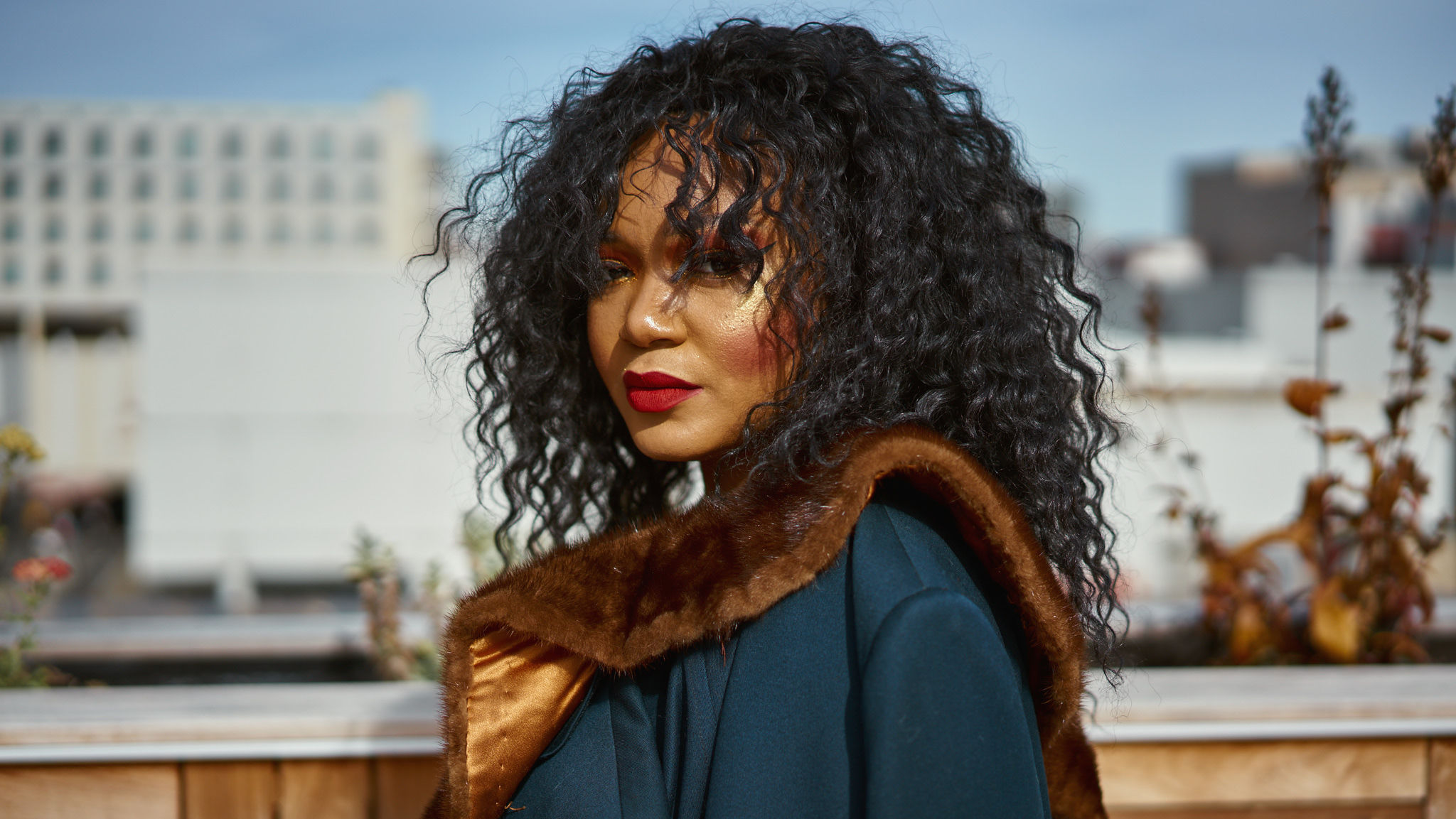 Image of Camille Bell in an outdoor space, looking into camera