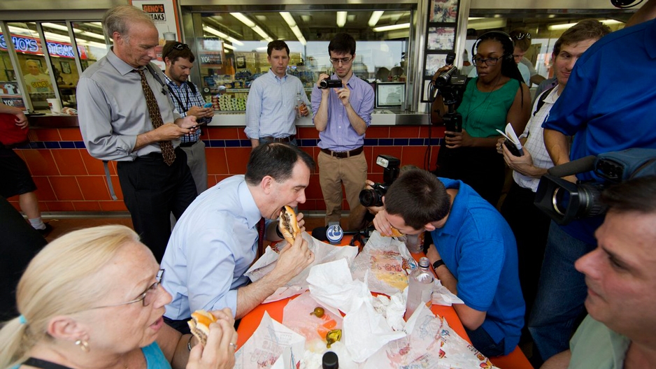 A political candidate eating a cheesesteak in Philadelphia.