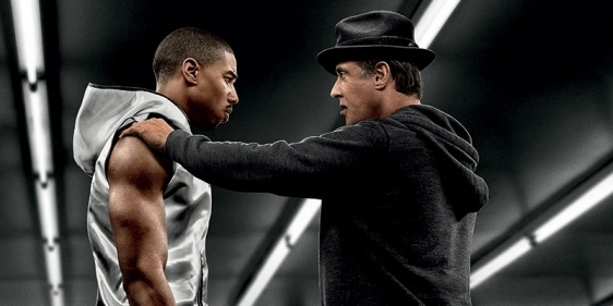 A poster promoting the film Creed with stars posing in a boxing ring.