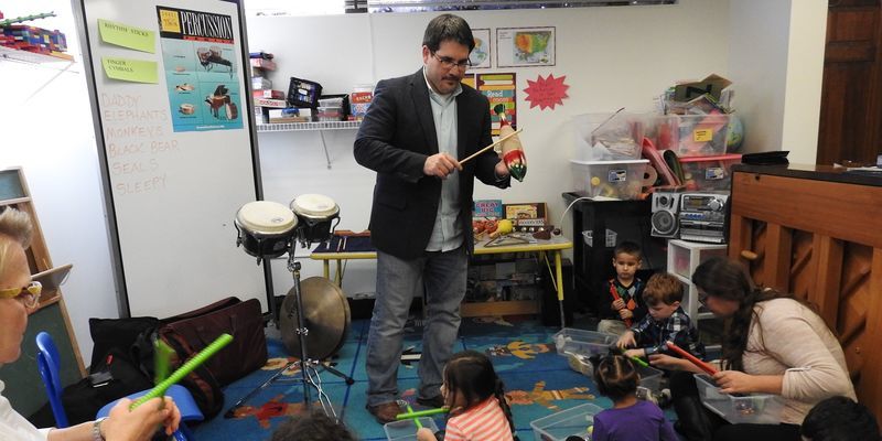 Steven Weiser, BYR ’02, ’04, teaches a percussion lesson to a group of students.