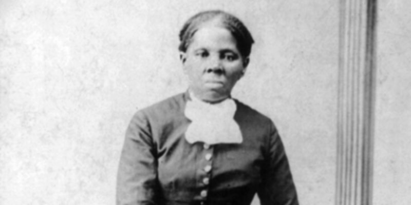 Image of Harriet Tubman standing against a chair.