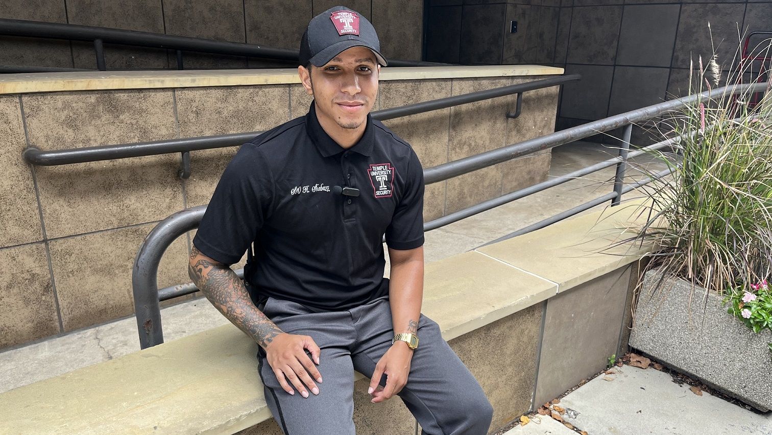 Heru Shabazz pictured sitting outside the offices of the Department of Public Safety.