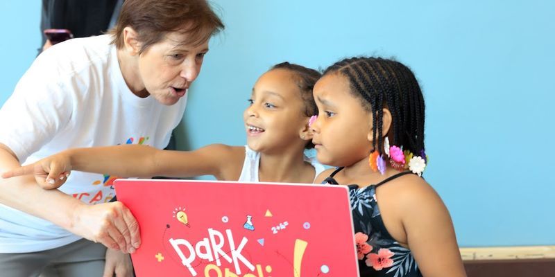 Kathy Hirsh-Pasek interacting with two young students
