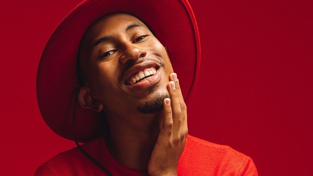 Kalen Allen posing in red.