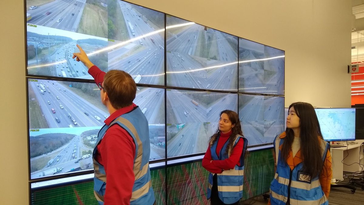 Researchers review data on a screen.