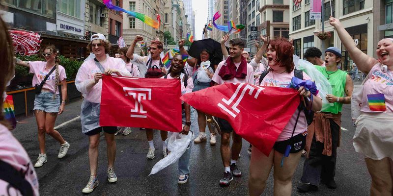 Students holding Temple flags at NYC Pride