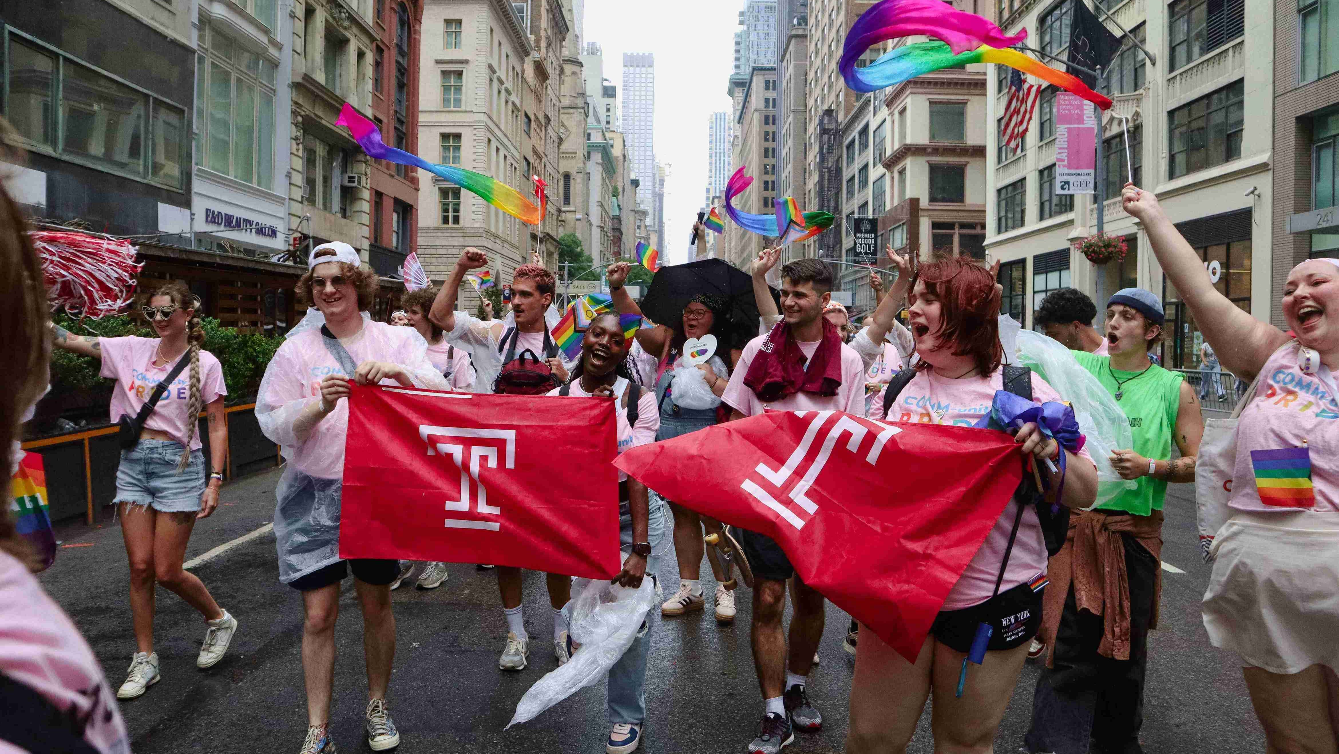Students holding Temple flags at NYC Pride