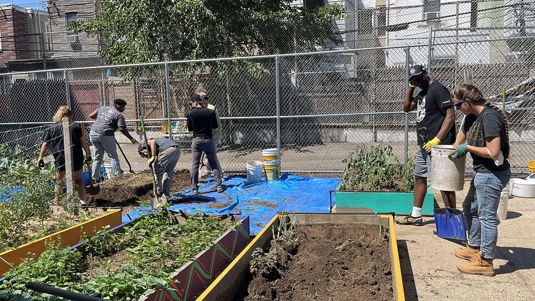 Students outside working on a garden.