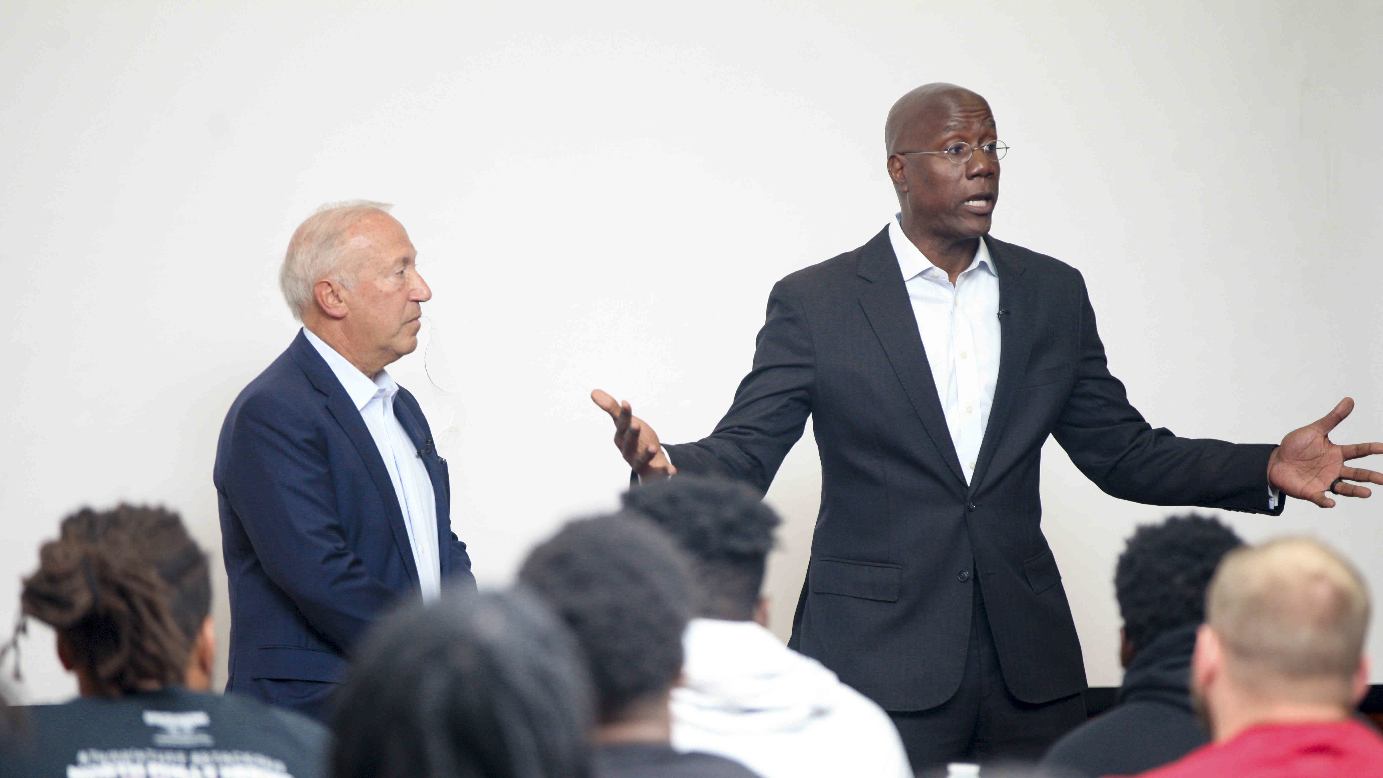 Board of Trustees Chair Mitchell Morgan and President Jason Wingard addressing the football team.