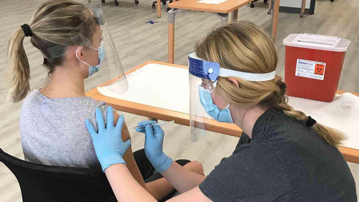 Temple School of Pharmacy students being trained to give vaccines.