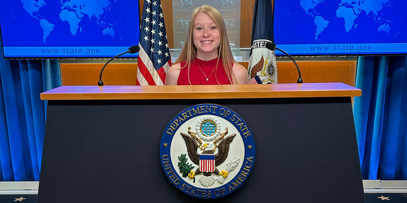 Mergen at State Department podium