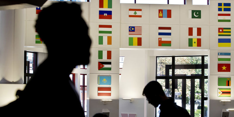 International flags hang in the Howard Gittis Student Center