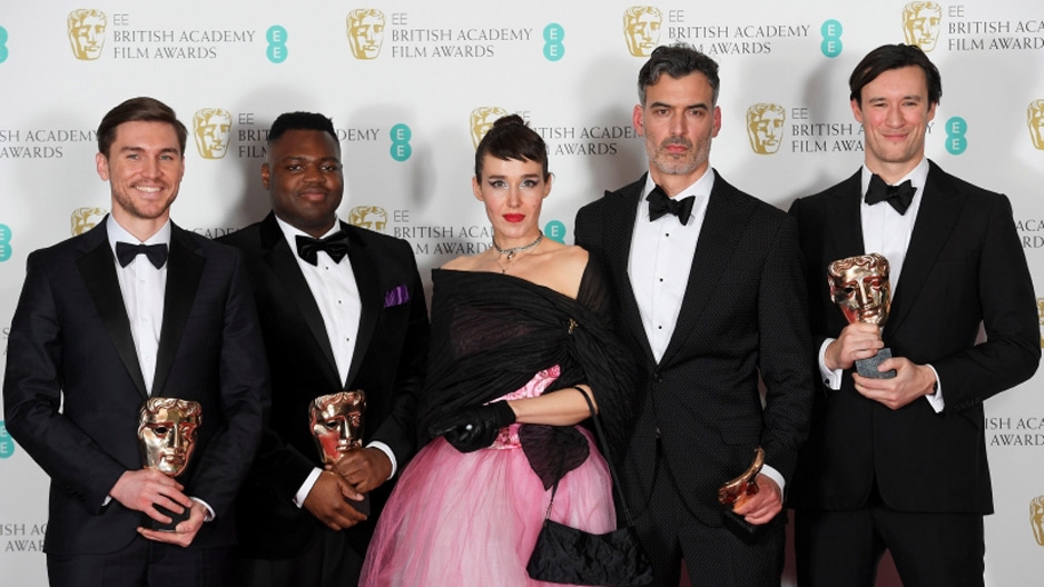 four men and a woman holding British Academy of Film and Television Arts awards.