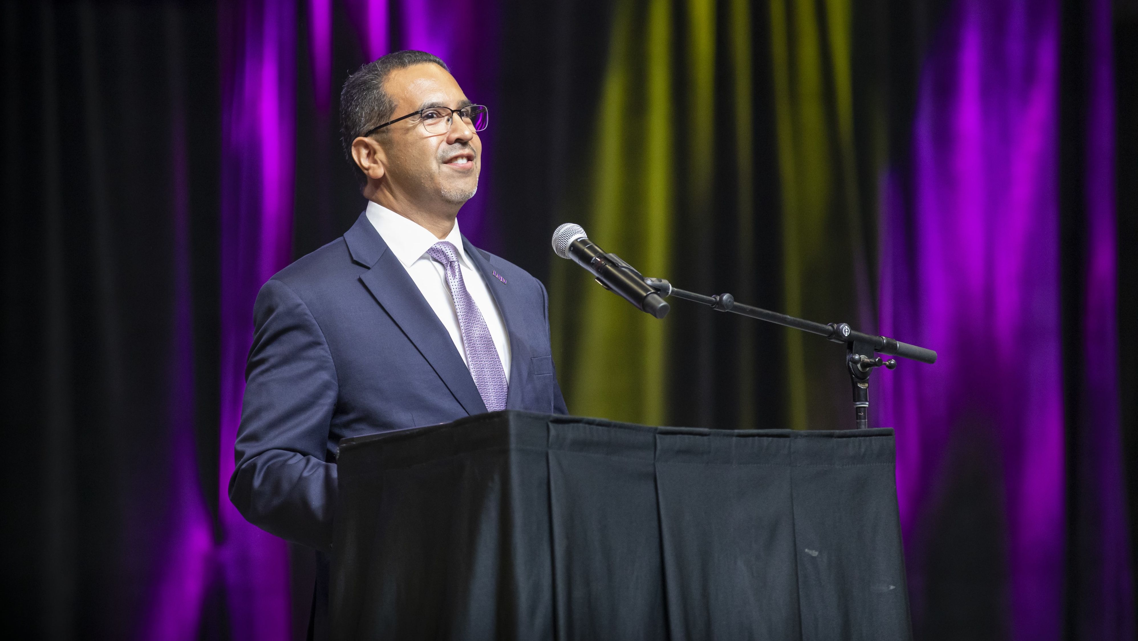 Jose Aviles speaking at a podium