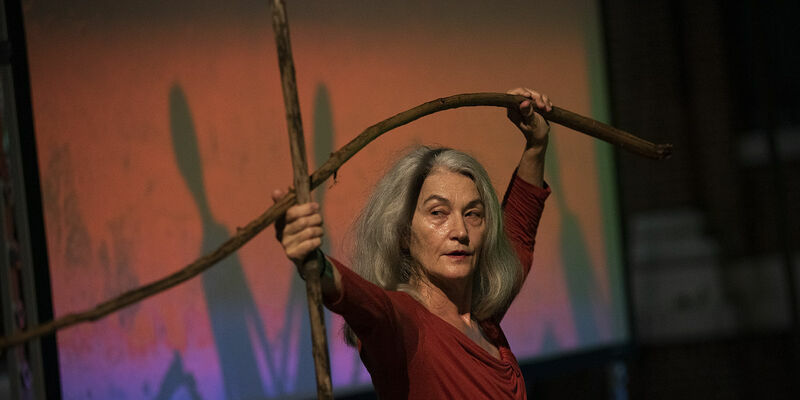 Merián Soto holding branches as part of her choreography 