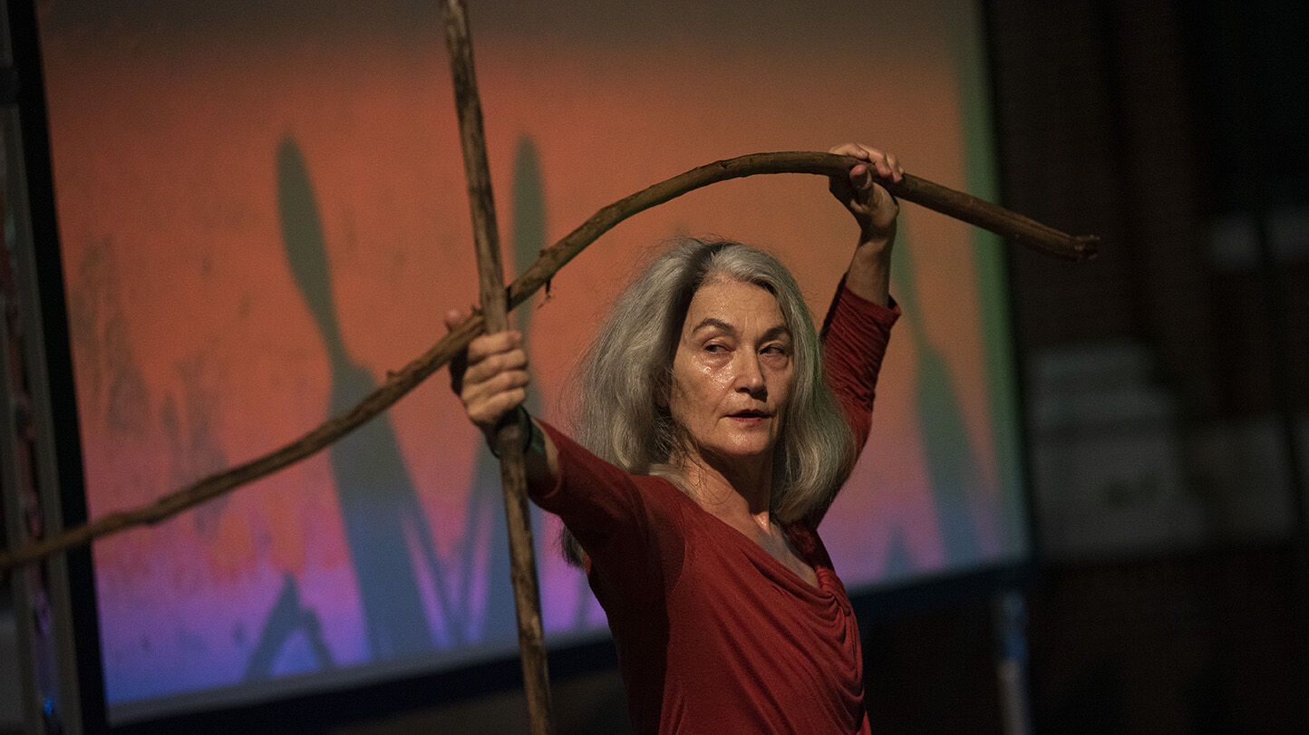 Merián Soto holding branches as part of her choreography 