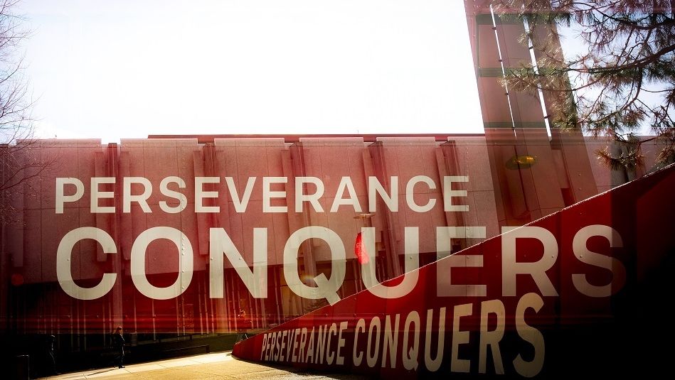 a sign that says Perseverance Conquers