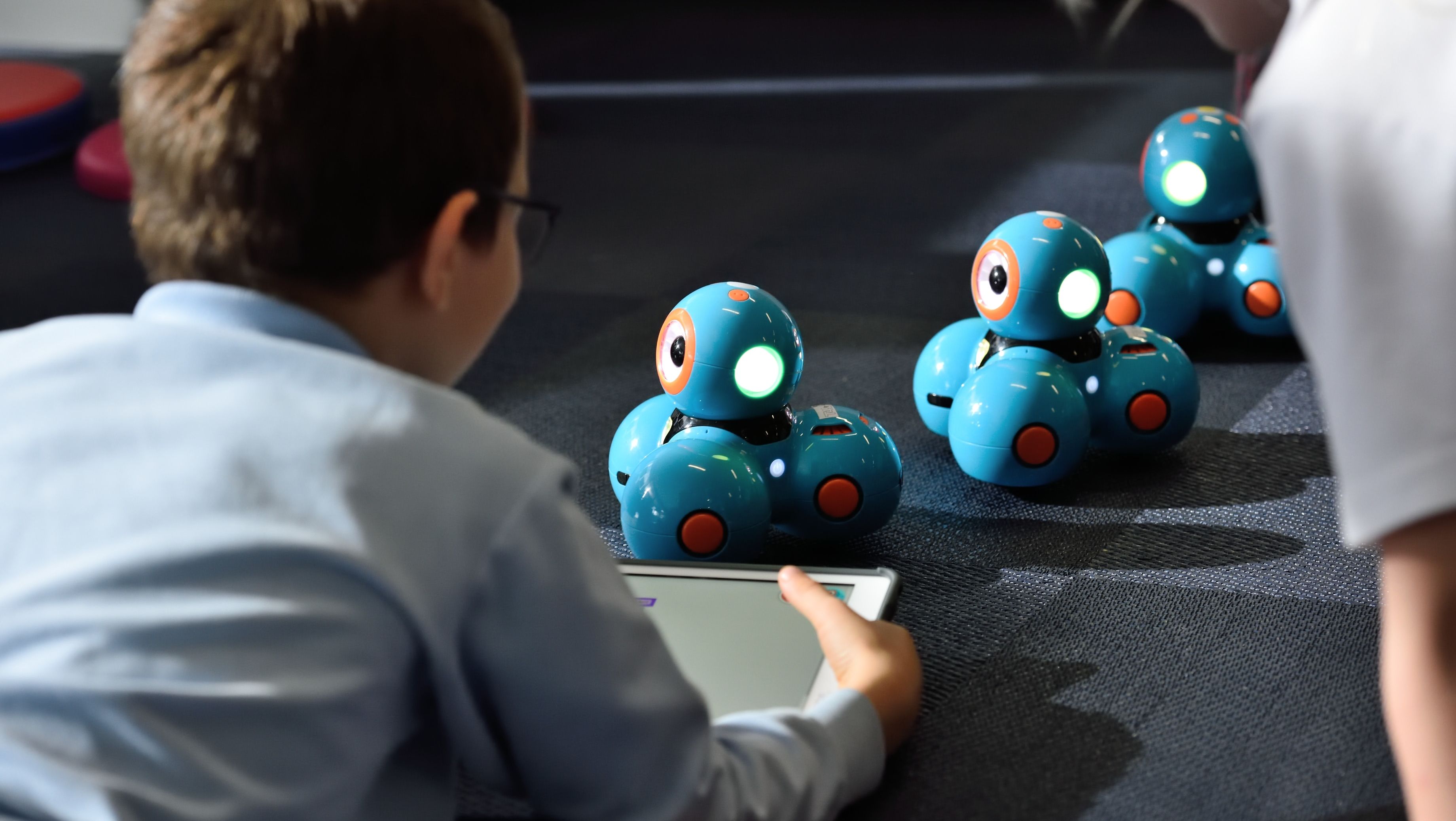 Image of a child playing with robot toys.