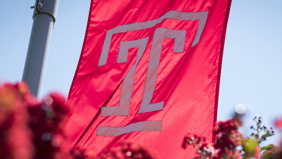 Temple flag flying above flowers