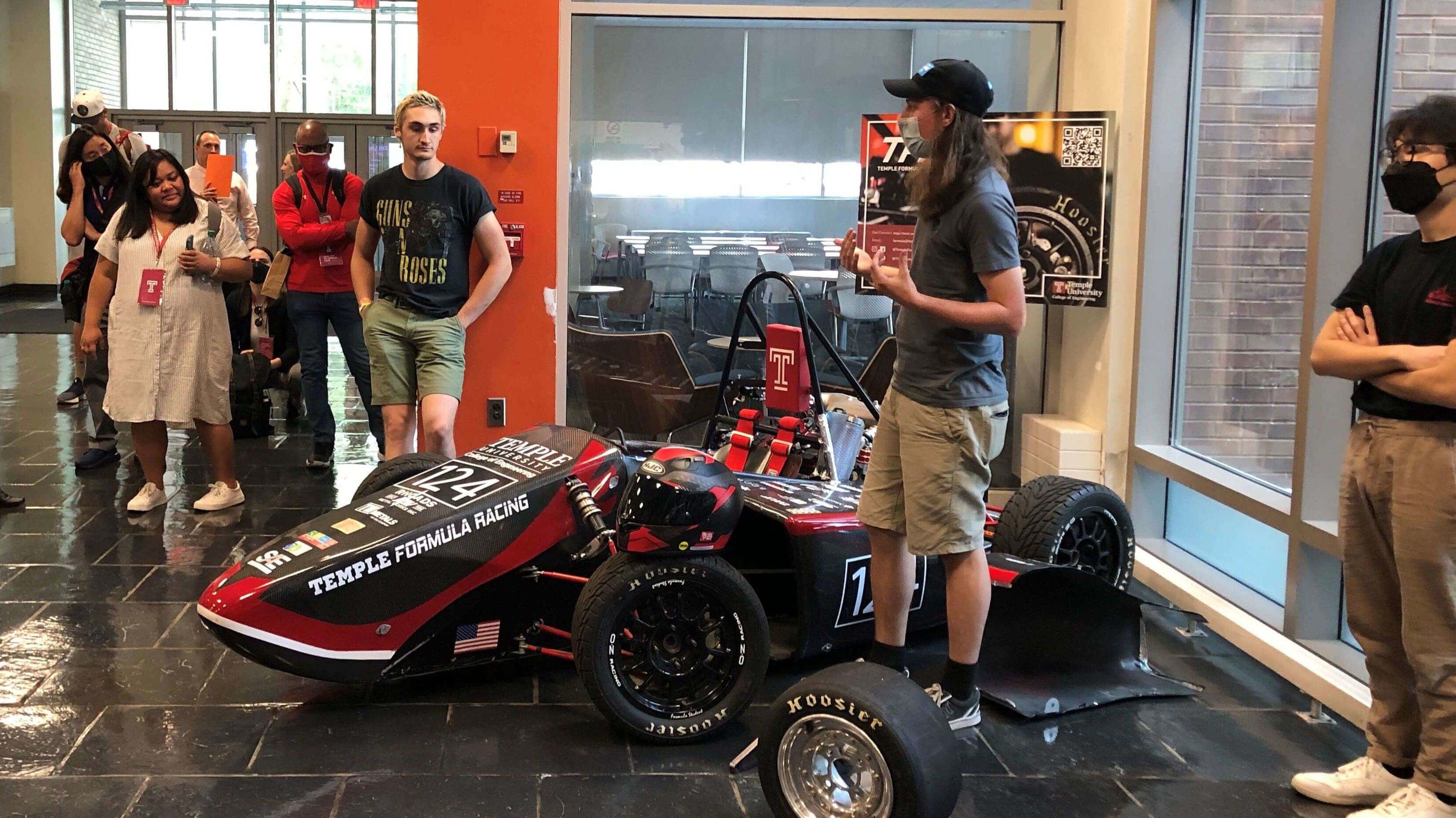 Image of Temple Formula Racing students showing others their 2018 race car.