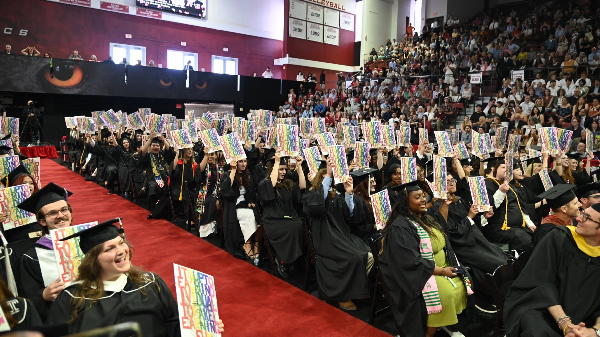 Tyler graduates holding up their Diploma Project print