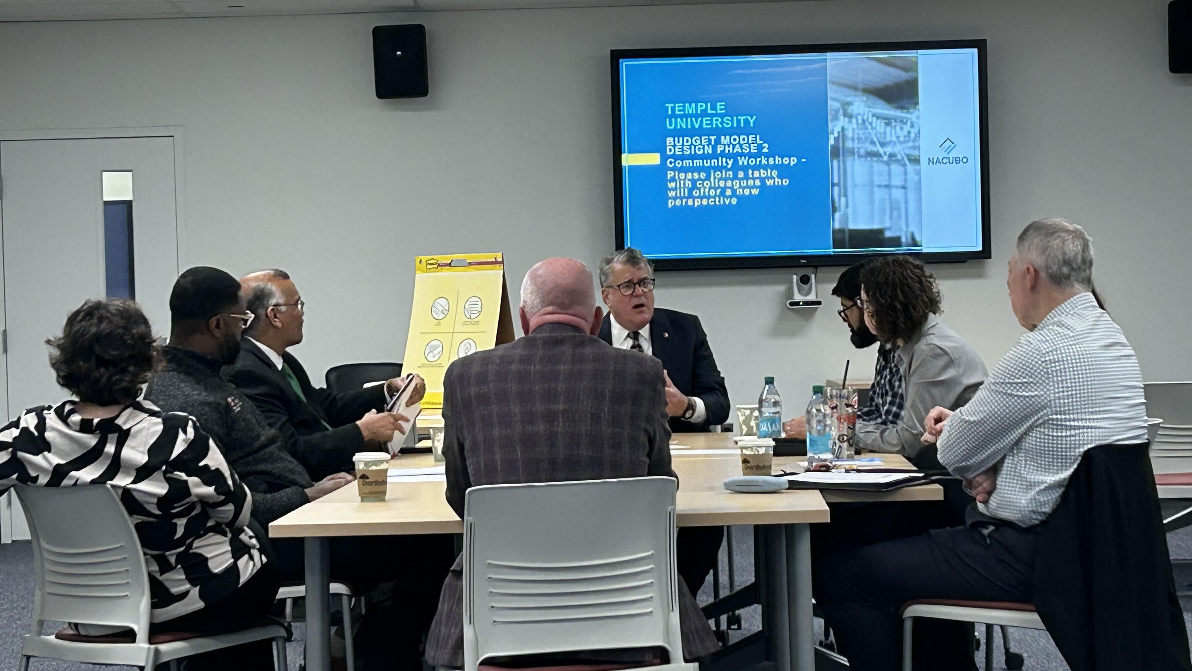 An image of folks around a table at a budget workshop.