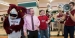 Ken and Kevin Acker celebrating with Hooter at a pop-up pride event.