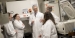 A team of scientists talking in a laboratory.