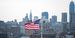 Image of an American flag in front of the Philadelphia skyline.